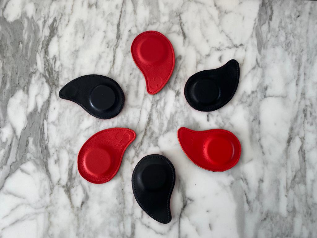 Biomagnet pairs laid out in a circle on a marble surface.